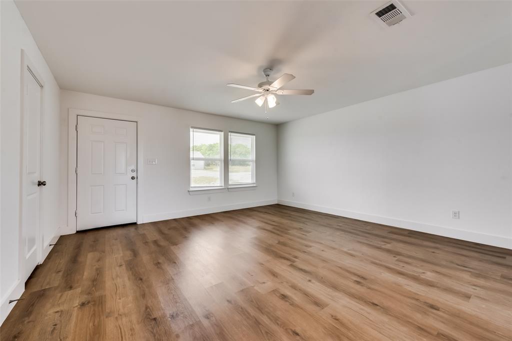 114 Nail Court, Unit 100 Decatur, TX 76234 - Photo 2 of 14 wooden floor in an empty room with a window