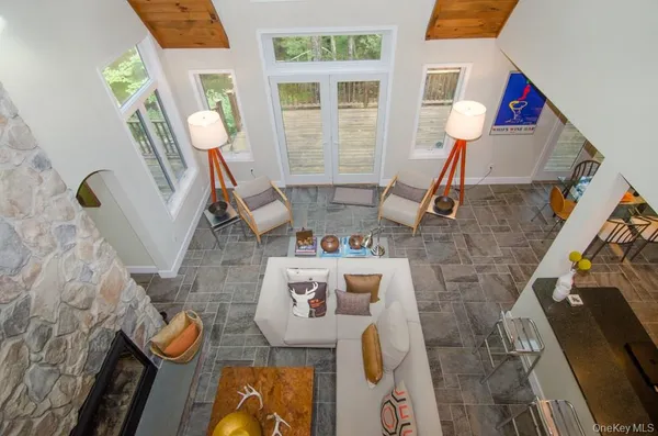 a living room with furniture and a floor to ceiling window