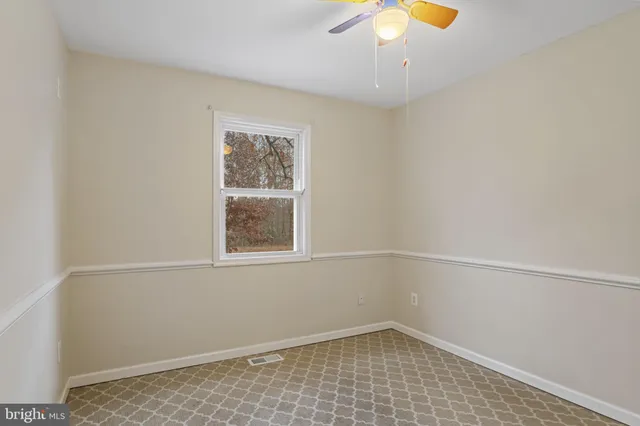 an empty room with cabinet and window