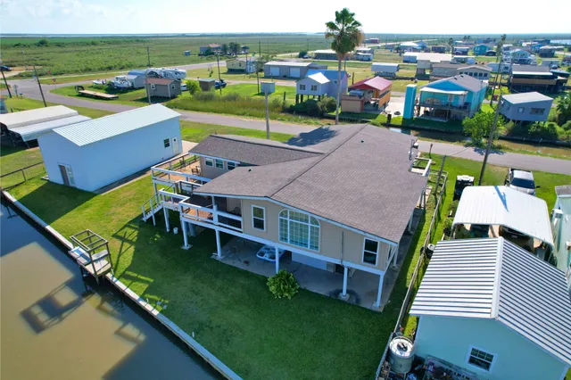an aerial view of a house with pool table and chairs