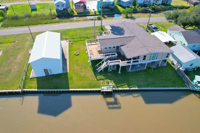 an aerial view of a house with a lake view