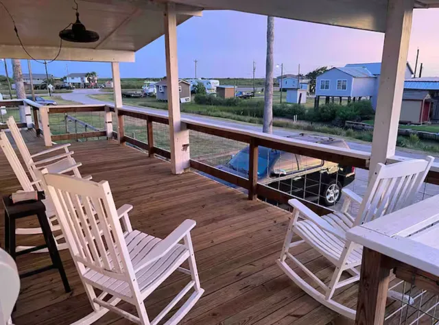 a view of a chairs and table in the balcony
