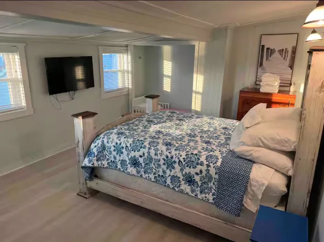 a bedroom with a bed and a flat screen tv
