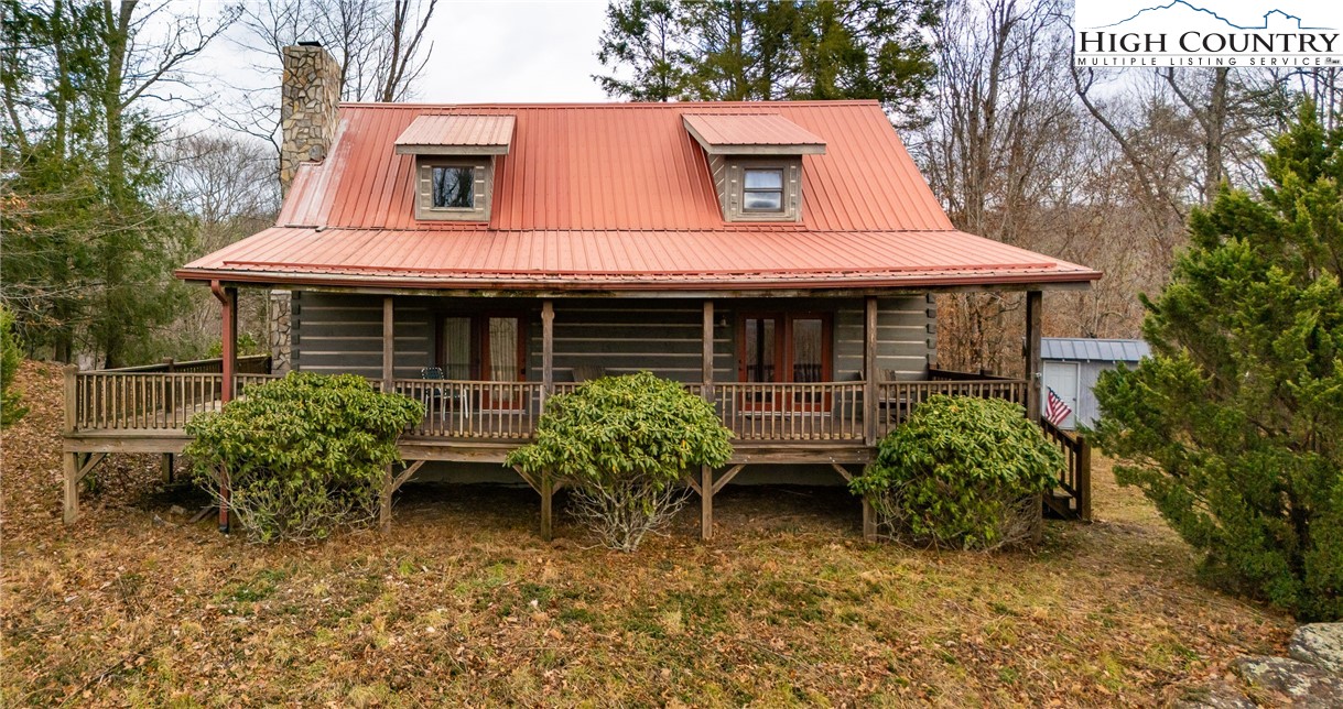 130 Timber Ridge Road Sugar Grove, NC 28679 - Photo 1 of 34 a house with lots of trees in front of it