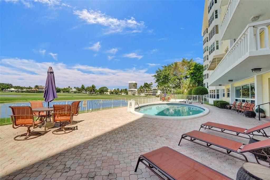 2500 Northeast 48th Lane, Unit 403 Fort Lauderdale, FL 33308 - Photo 22 of 24 a view of a swimming pool with lounge chairs