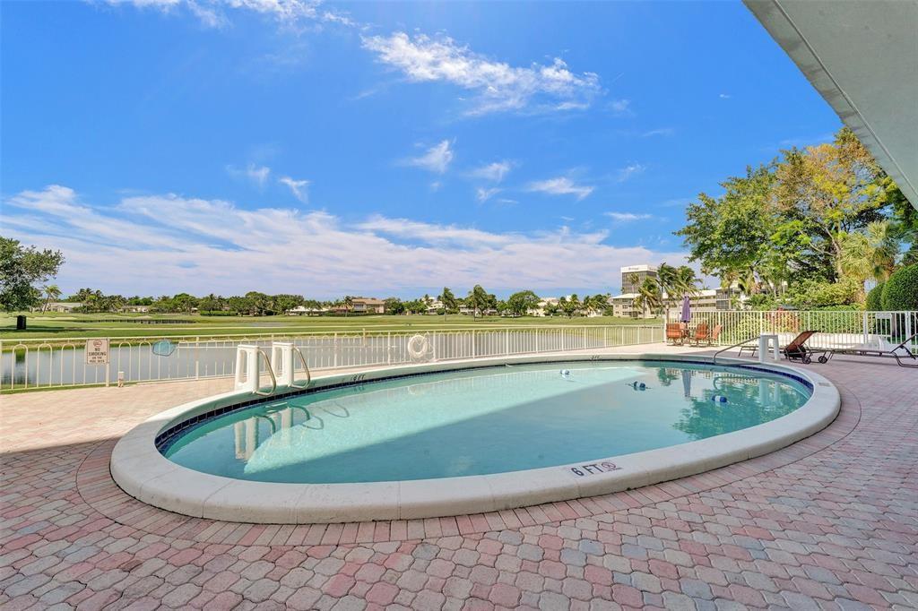 2500 Northeast 48th Lane, Unit 403 Fort Lauderdale, FL 33308 - Photo 23 of 24 a view of a swimming pool and an outdoor seating