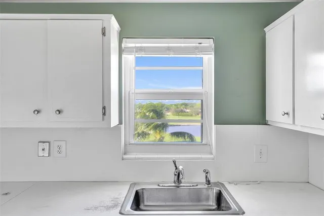 a kitchen with a sink a stove and cabinets
