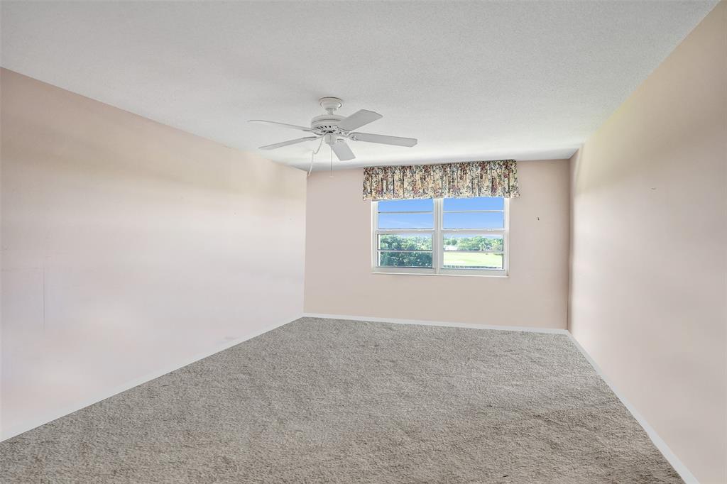 2500 Northeast 48th Lane, Unit 403 Fort Lauderdale, FL 33308 - Photo 9 of 24 an empty room with windows and entrance