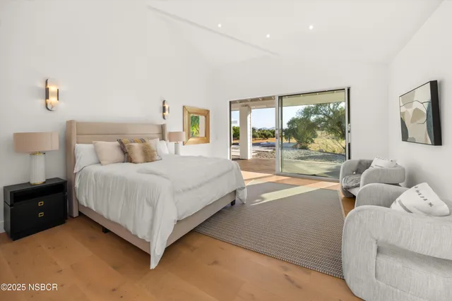 a bedroom with a bed and glass window