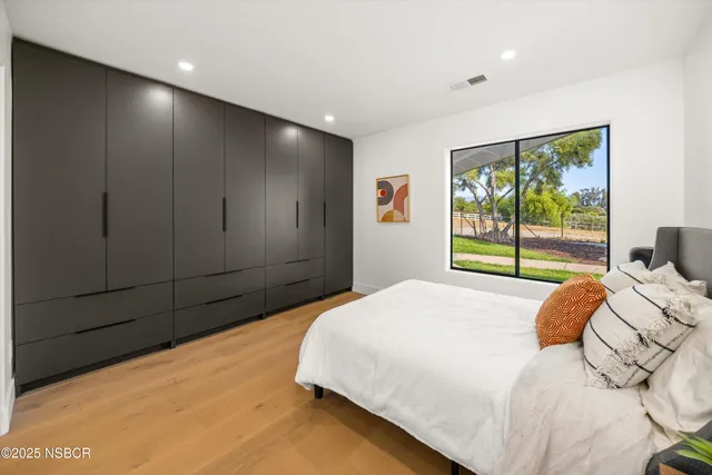 a bedroom with a large bed and a large window