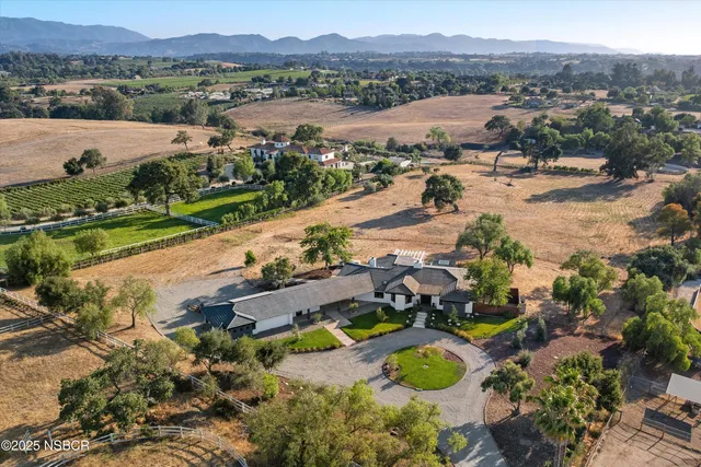 an aerial view of lake residential house and swimming pool