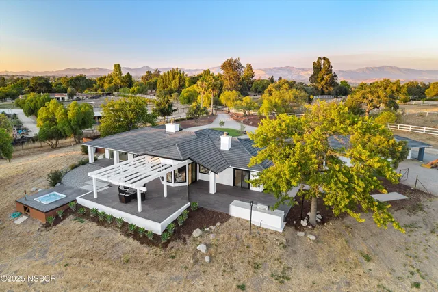 a view of a terrace with a garden and trees