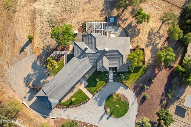 an aerial view of a house with yard swimming pool and outdoor seating
