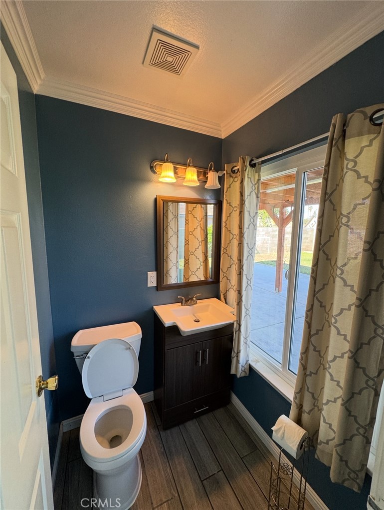 7627 Key W Drive Riverside, CA 92503 - Photo 5 of 7 a bathroom with a toilet sink and mirror