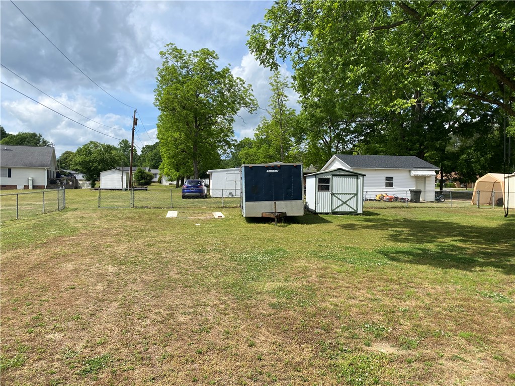 3 Heyward Avenue Honea Path, SC 29654 - Photo 26 of 35 This spacious yard offers versatile outdoor storage and privacy, ideal for various needs.