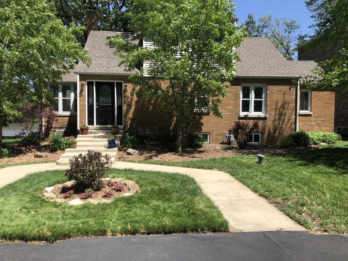 3137 River Road Kankakee, IL 60901 - Photo 1 of 44 a front view of a house with a garden and plants