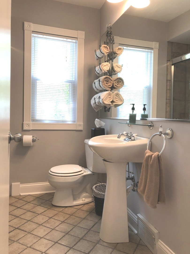 3137 River Road Kankakee, IL 60901 - Photo 17 of 44 a bathroom with a sink toilet and mirror