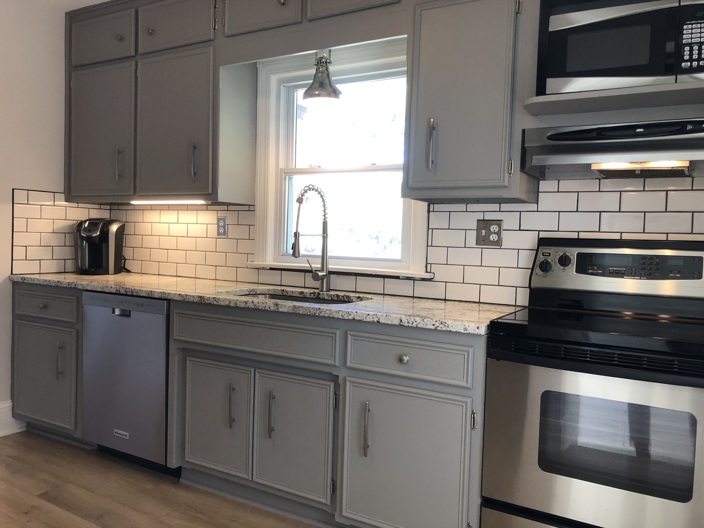 3137 River Road Kankakee, IL 60901 - Photo 8 of 44 a kitchen with granite countertop white cabinets appliances and a sink