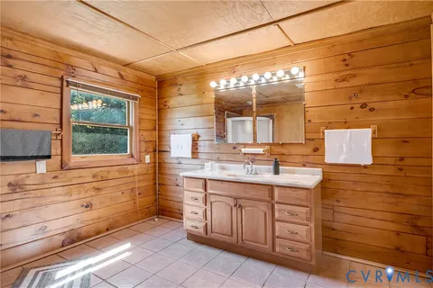 a bedroom with a bed mirror and window