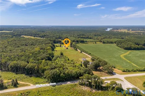 a view of a lake with lawn chairs