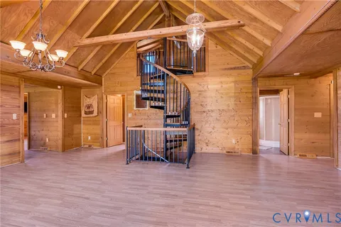 a view of a livingroom with wooden floor and furniture