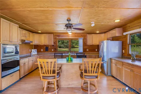 a kitchen with stainless steel appliances granite countertop a sink a stove and cabinets
