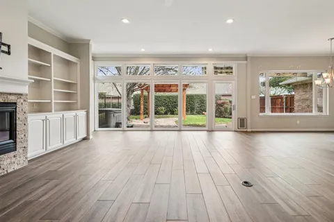 wooden floor in an empty room with a large window