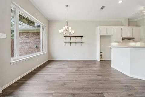 a view of a kitchen with a dishwasher cabinets and a wooden floor