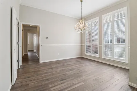 a view of livingroom with window wooden floor and chandelier