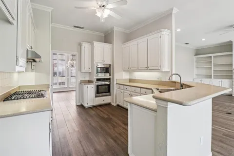 a kitchen with a stove a sink and a refrigerator