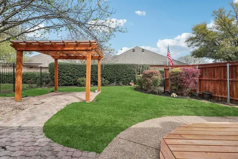 a aerial view of a house with a yard and potted plants