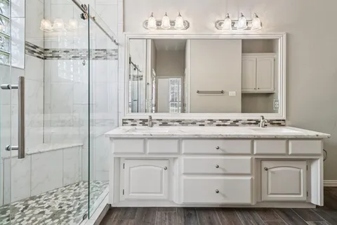 a bathroom with a sink vanity and a mirror