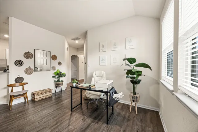 a living room with furniture and wooden floor