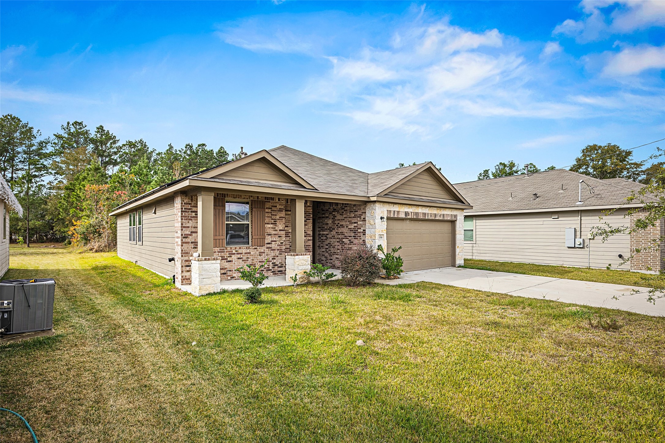 156 County Road Cleveland, TX 77327 - Photo 2 of 25 a view of a house with a big yard and large trees