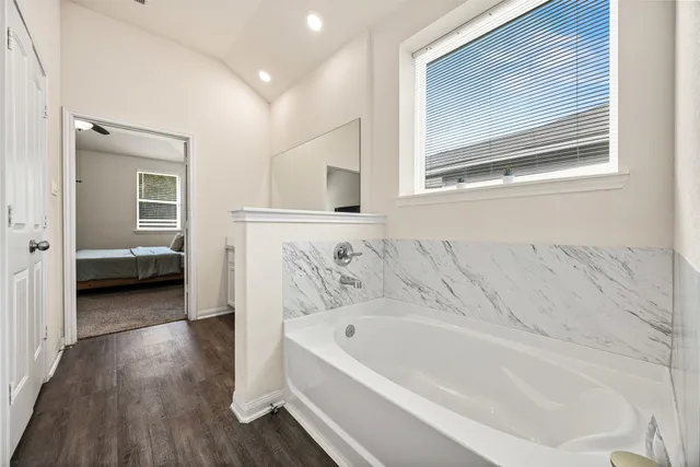 a bathroom with a bathtub and a sink