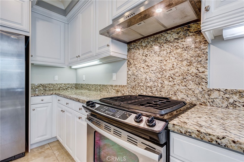 24 Oakfield Irvine, CA 92620 - Photo 11 of 30 a stove top oven sitting inside of a kitchen