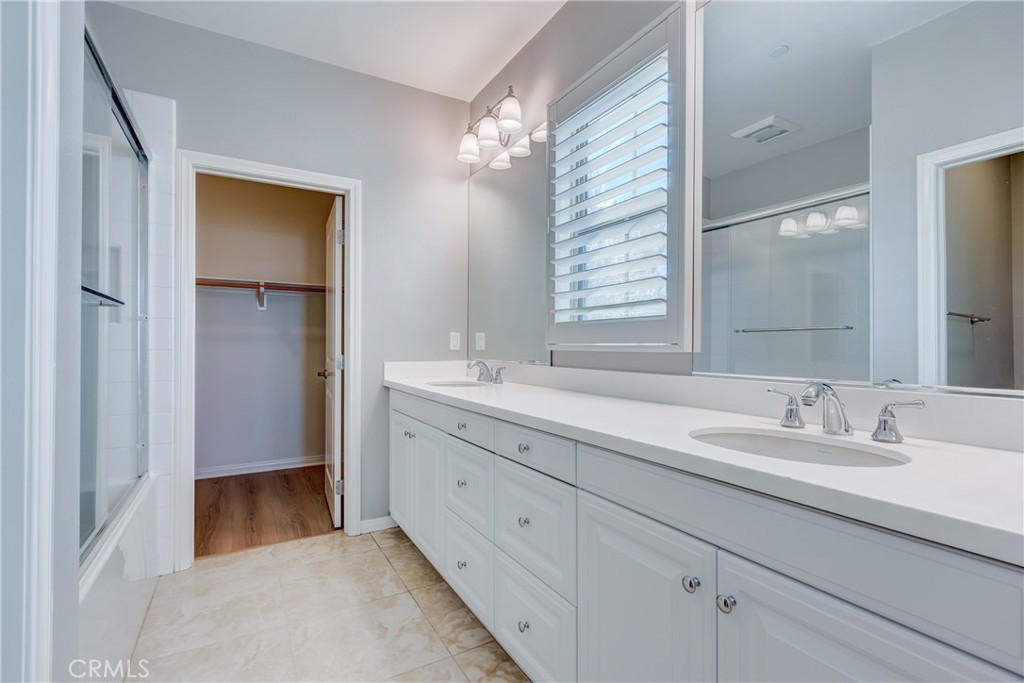 24 Oakfield Irvine, CA 92620 - Photo 18 of 30 a spacious bathroom with a double vanity sink a mirror and a shower