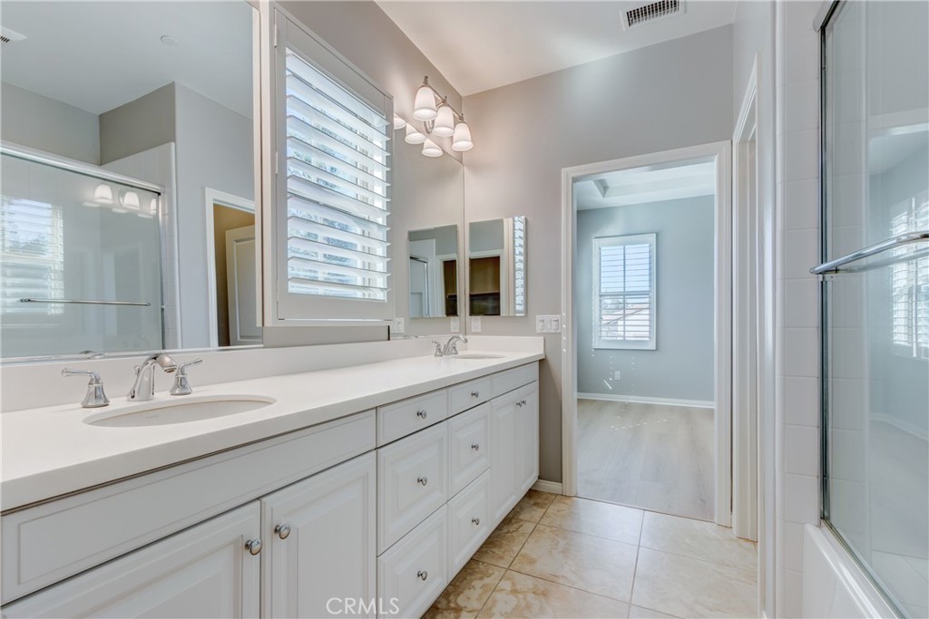 24 Oakfield Irvine, CA 92620 - Photo 19 of 30 a spacious bathroom with a double vanity sink and a mirror