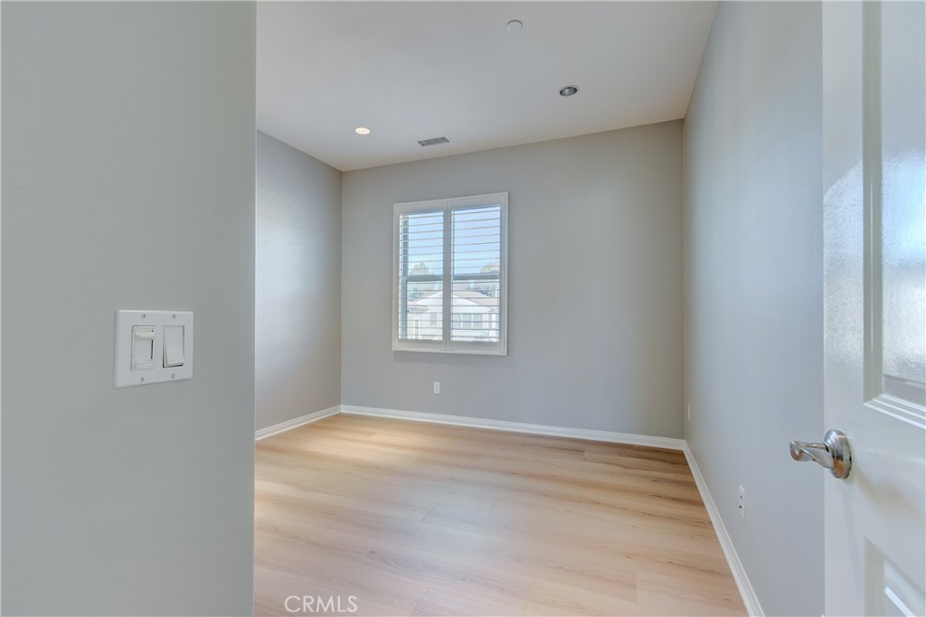 24 Oakfield Irvine, CA 92620 - Photo 20 of 30 a view of an empty room with wooden floor and a window
