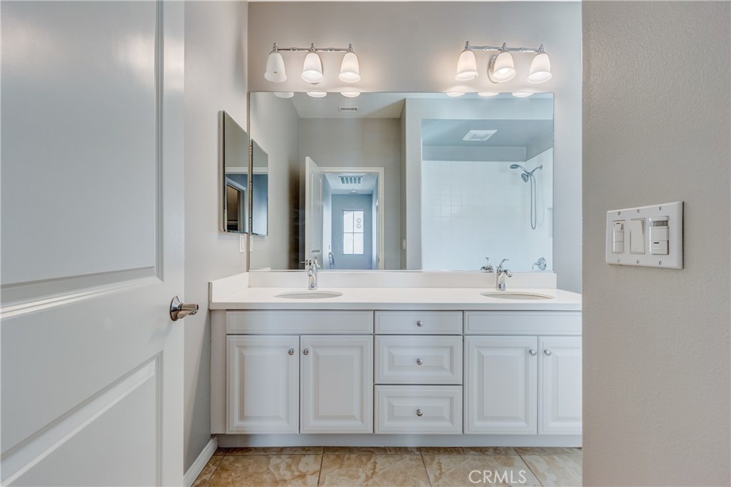 24 Oakfield Irvine, CA 92620 - Photo 24 of 30 a spacious bathroom with a granite countertop sink a mirror and a vanity