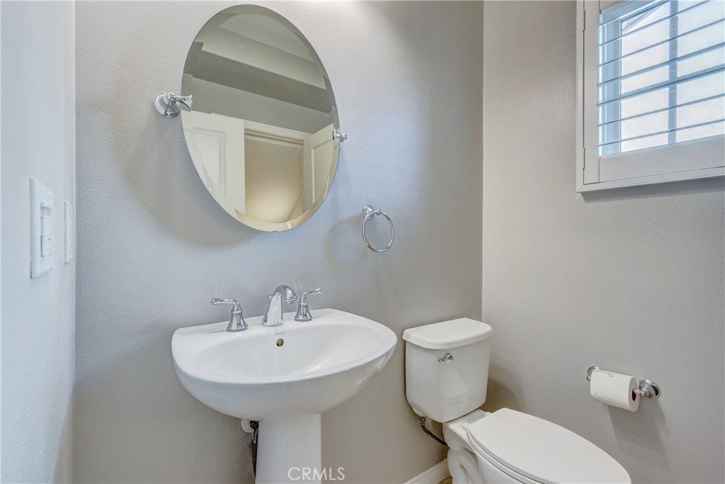 24 Oakfield Irvine, CA 92620 - Photo 5 of 30 a bathroom with a toilet a sink and mirror
