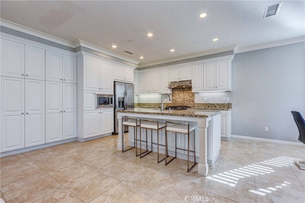 24 Oakfield Irvine, CA 92620 - Photo 8 of 30 a kitchen with counter top space cabinets and stainless steel appliances