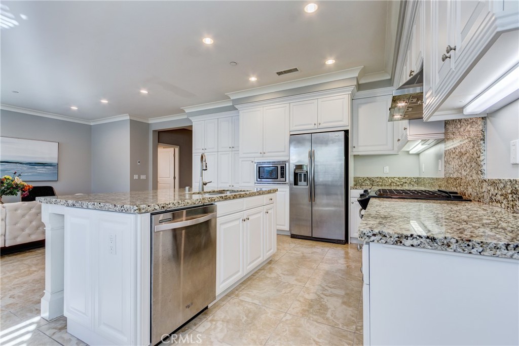 24 Oakfield Irvine, CA 92620 - Photo 9 of 30 a kitchen with stainless steel appliances granite countertop a refrigerator a stove and a sink