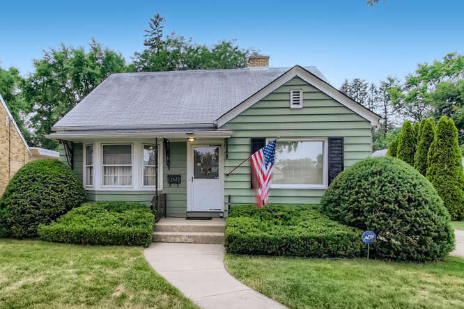 352 South Commonwealth Avenue Elgin, IL 60123 - Photo 1 of 29 a front view of a house with garden