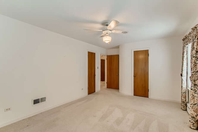 352 South Commonwealth Avenue Elgin, IL 60123 - Photo 14 of 29 an empty room with a ceiling fan and a window