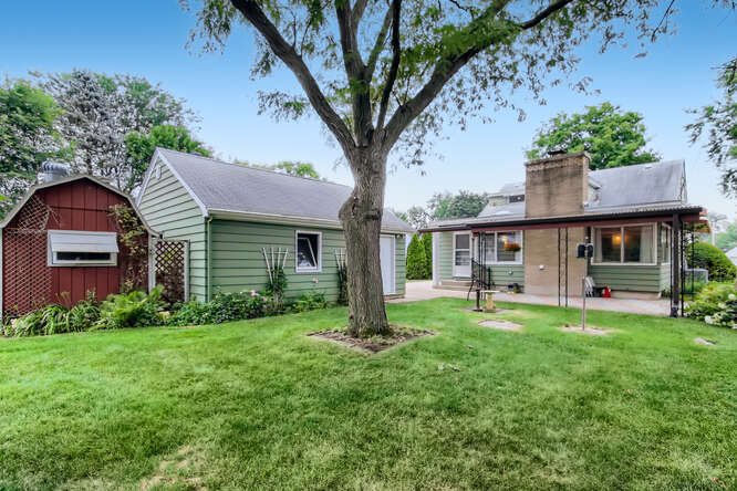 352 South Commonwealth Avenue Elgin, IL 60123 - Photo 29 of 29 a house view with a sitting space and garden
