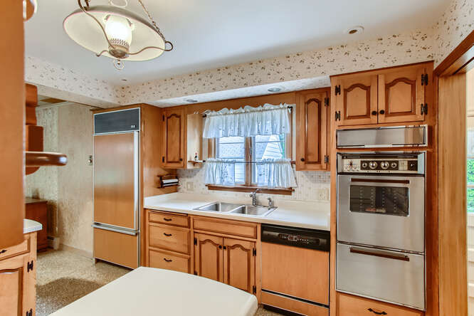 352 South Commonwealth Avenue Elgin, IL 60123 - Photo 10 of 29 a kitchen with stainless steel appliances granite countertop a refrigerator a stove a sink and a dishwasher with wooden floor