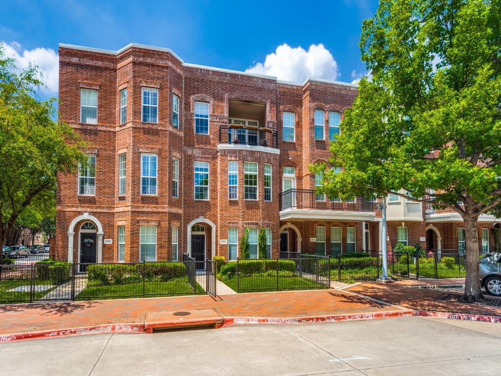 a view of a brick building next to a yard