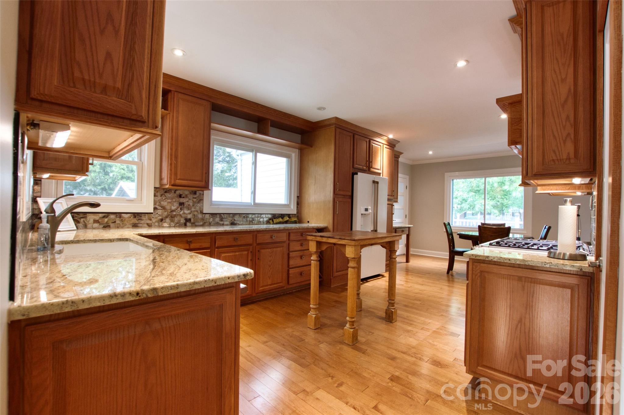 204 Clinton Avenue Clover, SC 29710 - Photo 8 of 26 a kitchen with stainless steel appliances granite countertop sink stove top oven and cabinets
