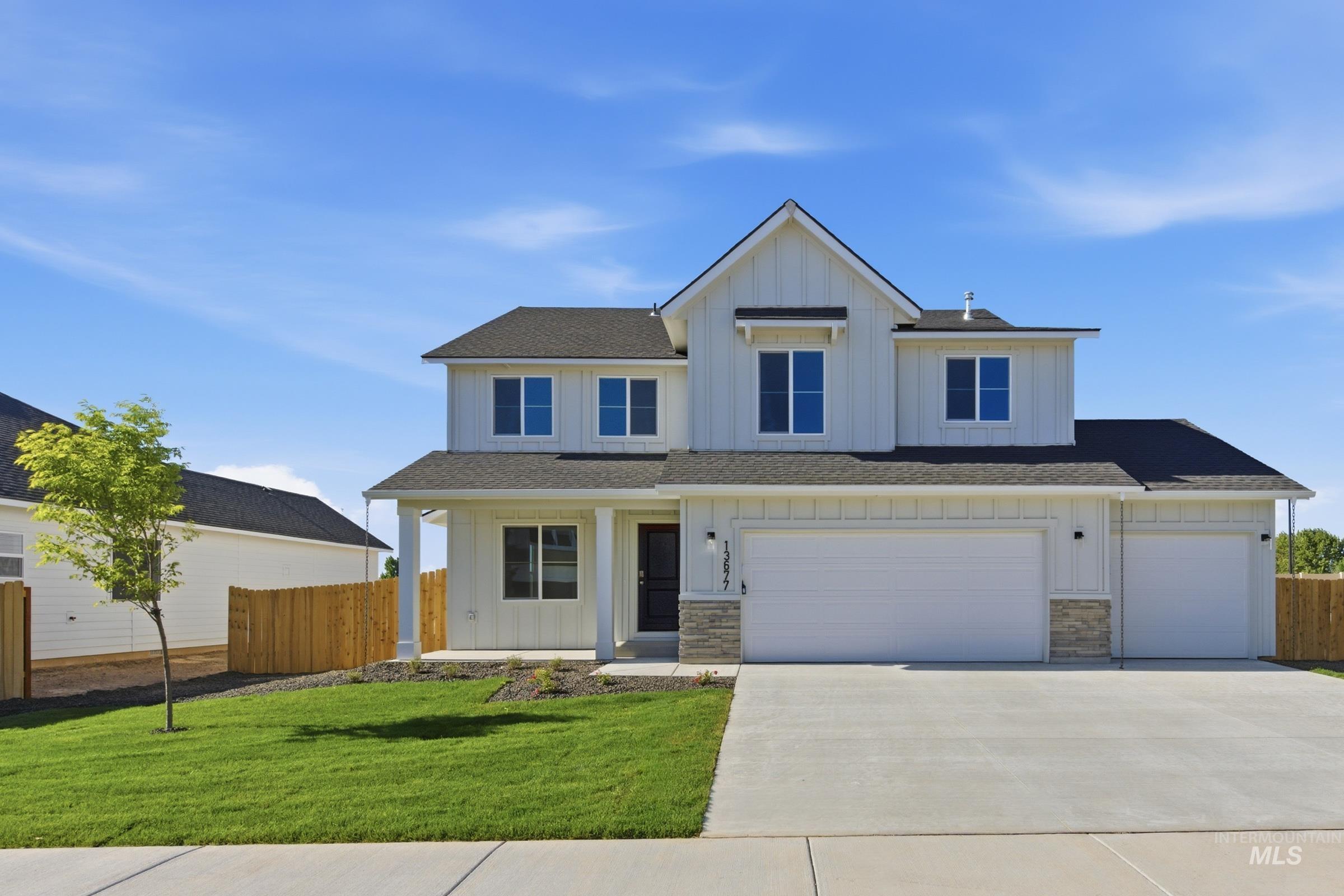 13677 Redway Court Caldwell, ID 83607 - Photo 1 of 35 Modern farmhouse-style exterior with white vertical siding, a covered front porch, and a dark asphalt shingle roof